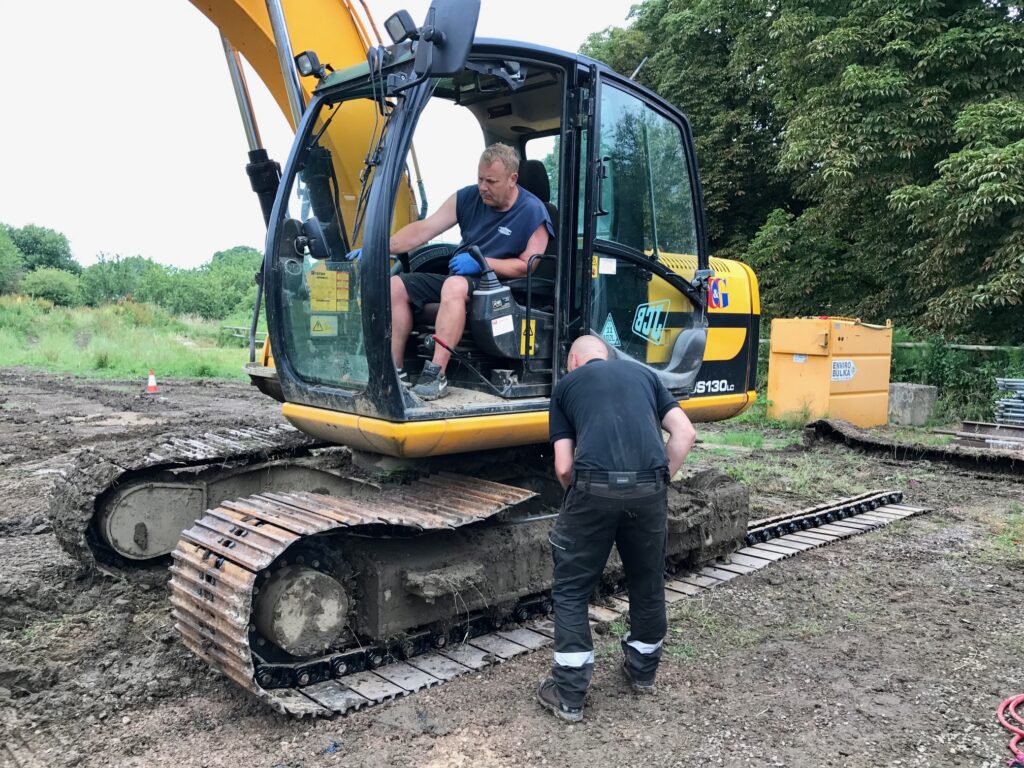 plant fitters on site with JCB