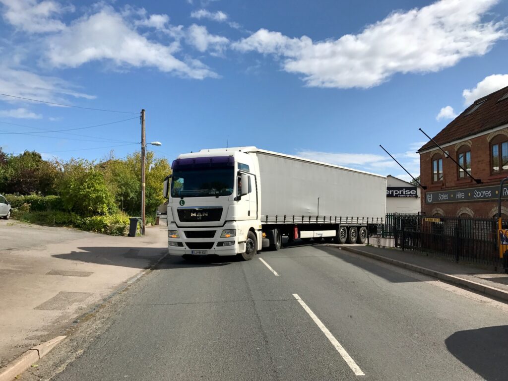 truck leaving jay bee plant sales depot with jcb excavator