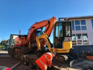 two excavators leaving jay bee plant sales for Scotland